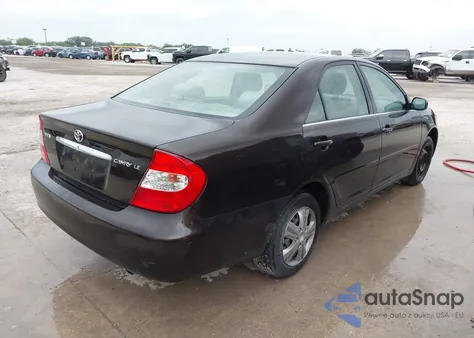 2002 Toyota Camry Le z USA, uszkodzony, nr VIN JTDBE32K720119418